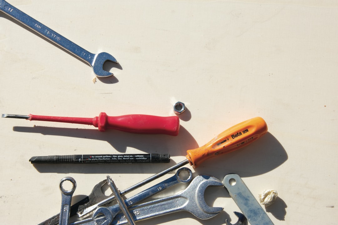 Close-up of a roofer's hardhat with various roofing tools like a hammer and utility knife, symbolizing a professional contractor.