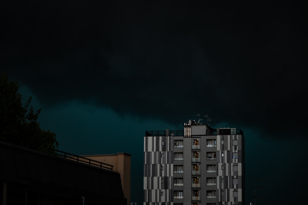Southeast-style suburban home stands under a dark, dramatic, and stormy sky, representing the threat of insurance non-rene...