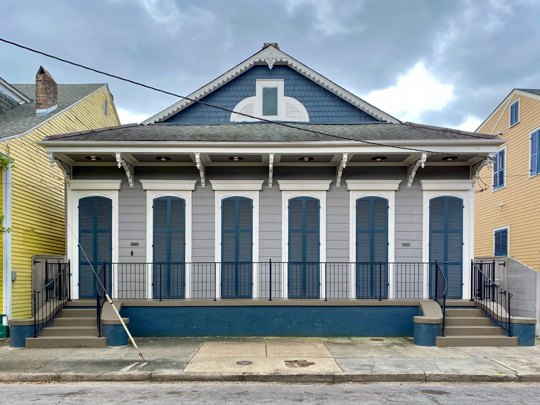 Beautiful New Orleans or Gulf Coast style home with a brand new, sturdy roof under a clear, sunny sky, representing a secu...