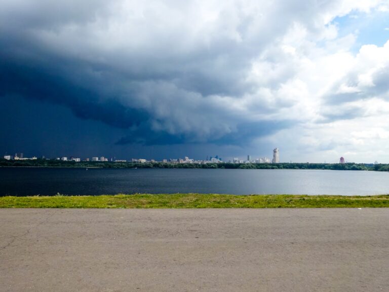 Dark, ominous storm clouds gathering over a residential neighborhood, illustrating the severe weather challenges faced by ...