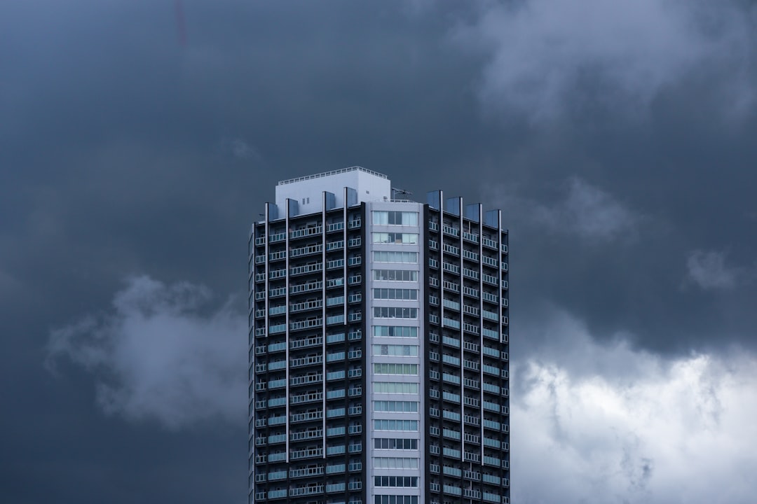 Dramatic, dark storm clouds gathering over a suburban house, emphasizing the threat of severe Gulf Coast weather and the need for a durable roof.