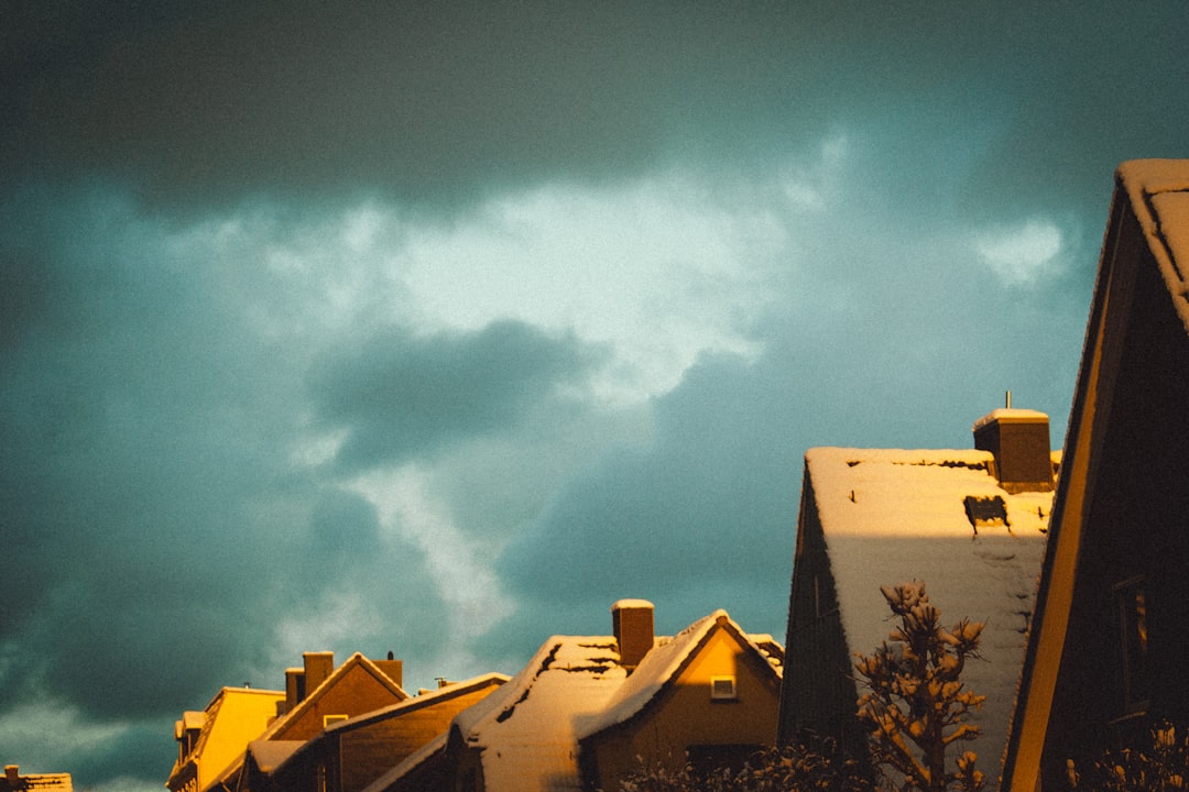 A resilient house standing strong against distant storm clouds, illustrating preparedness and protection.. Photo by Pukima on Unsplash. A resilient house standing strong against distant storm clouds, illustrating preparedness and protection.