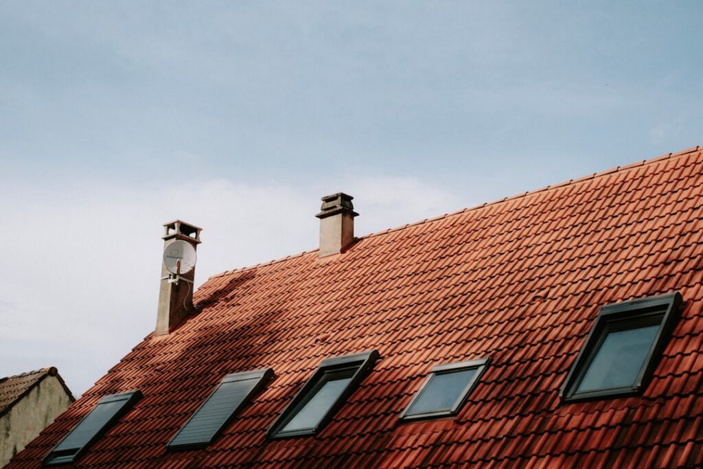 Sturdy home with a resilient roof on a sunny day, representing protection against severe weather.